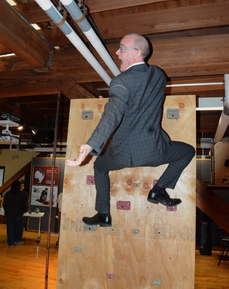 A climber in a suit on the wall