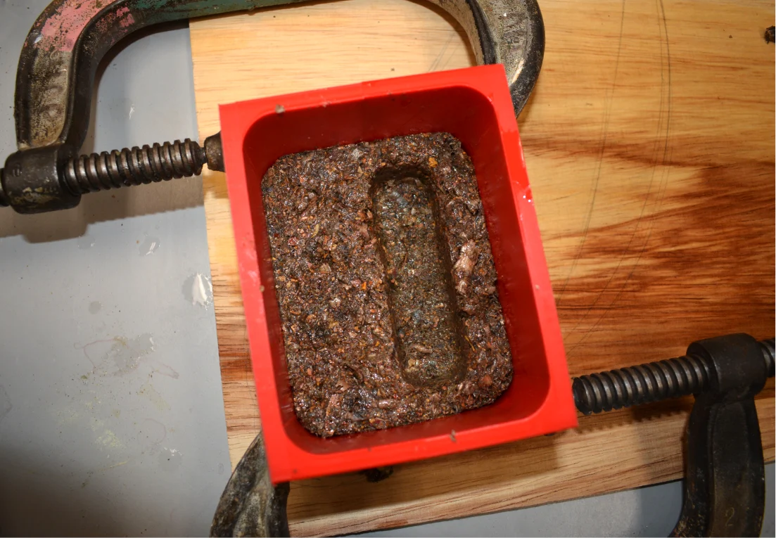 Composite packed into a mould and clamped
