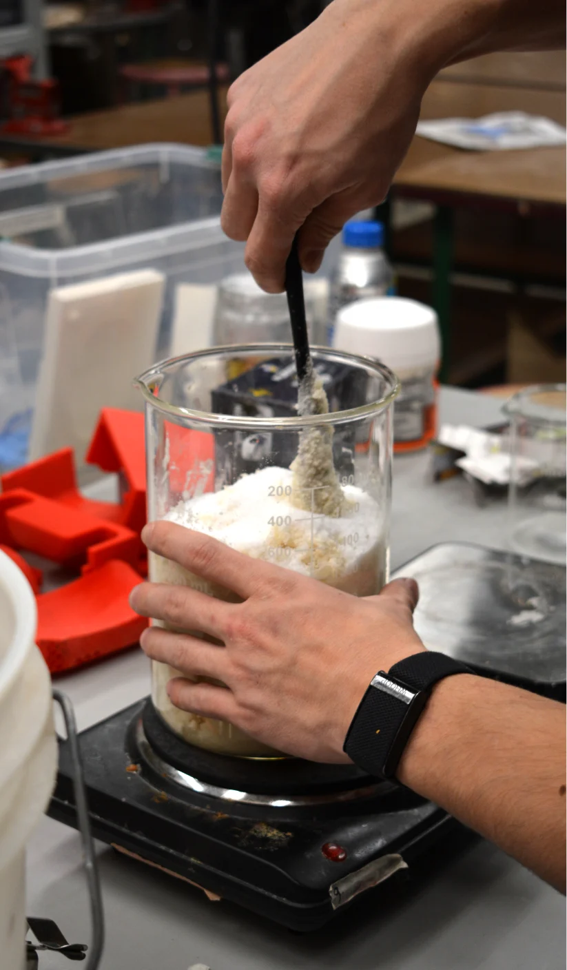 Stirring dry ingredients in a beaker on a scale