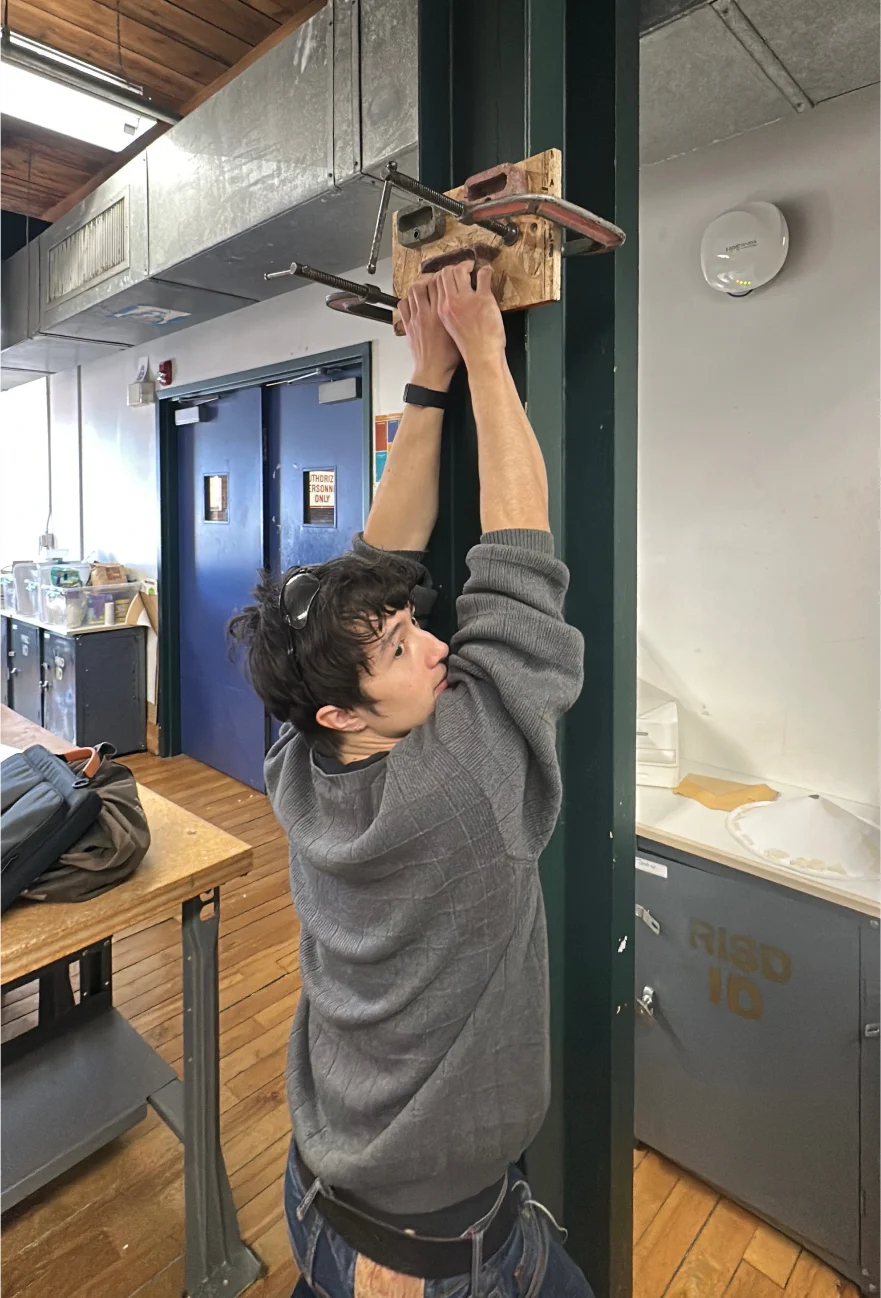 Hanging from a hold on the sample board